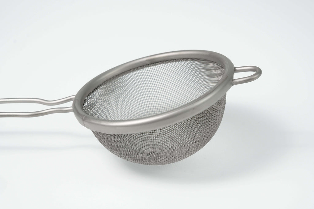 Metal mesh matcha strainer on a white background