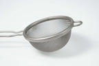 Metal mesh matcha strainer on a white background