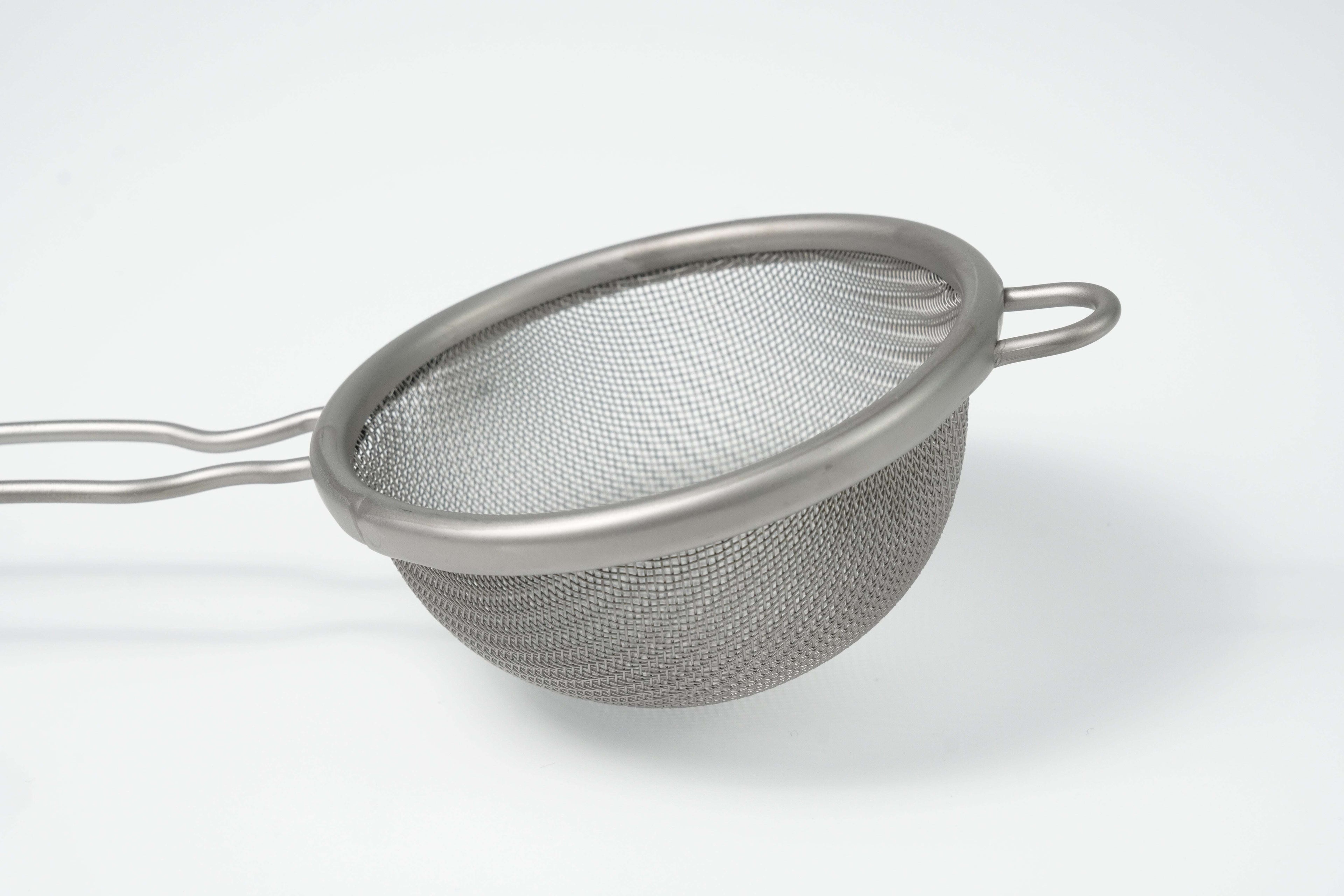 Metal mesh matcha strainer on a white background
