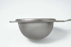 Metal mesh matcha strainer on a white background