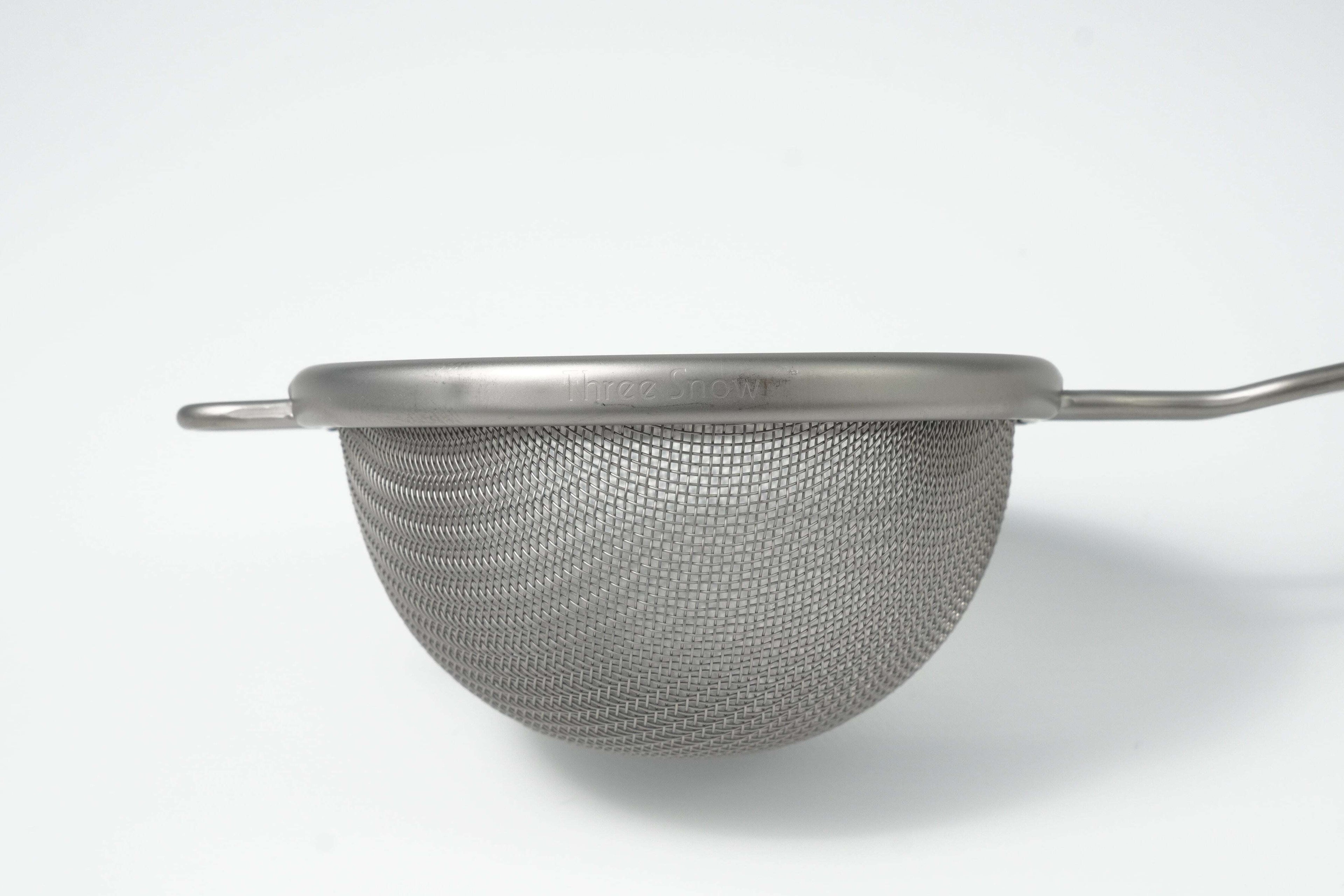 Metal mesh matcha strainer on a white background
